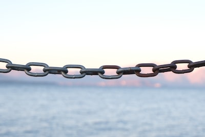 An image of a broken chain symbolizing debt discharge, with a backdrop of Hong Kong's iconic skyline