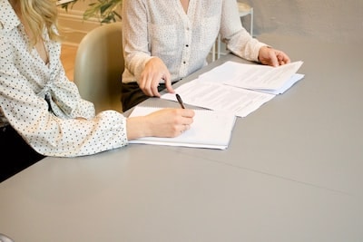 An image of a person holding a credit score report, with a clear division between debts eligible for discharge in Hong Kong bankruptcy (represented by fading lines) and those impacting their credit score (represented by bold, solid lines)